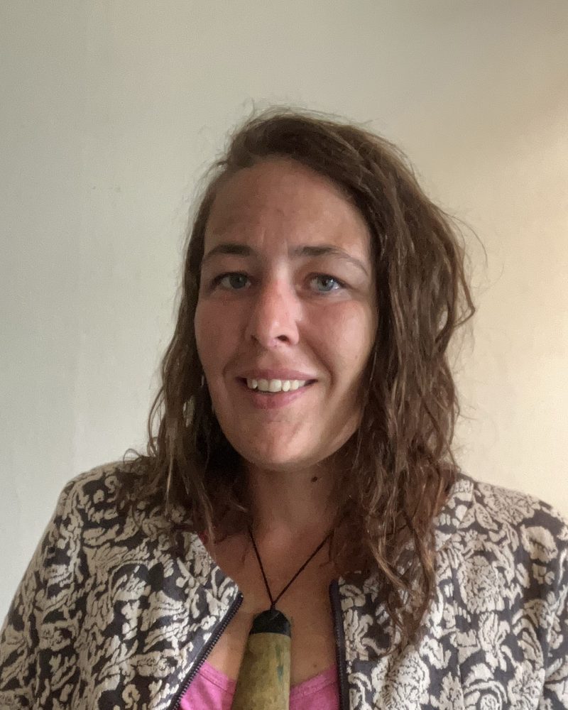 Jess, smiling, wearing a pounamu pendant